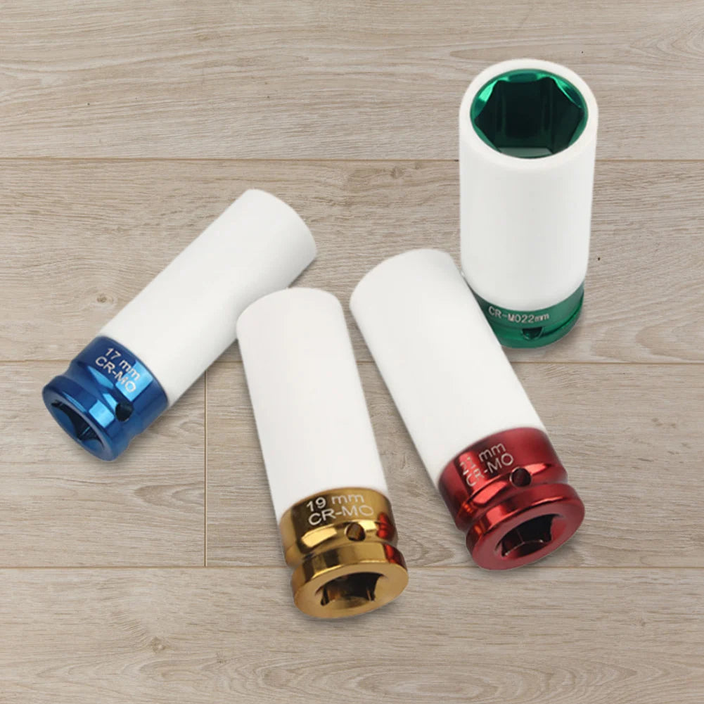 Four socket tool heads with different colored ends on a wooden surface